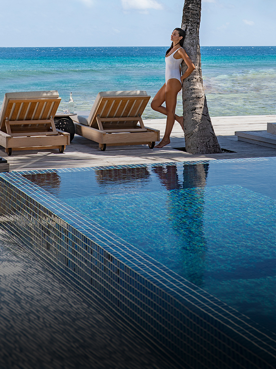 Guest enjoying the view and privacy of the Two Bedroom Beach Pool Residence at Naladhu Private Island Maldives