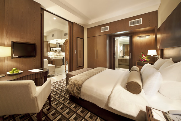 air conditioned bedroom with Wi-Fi access, comfortable double bed with clean sheets, en suite bathroom and satellite TV with foreign channels at Oaks Liwa Executive Suites hotel in Abu Dhabi, United Arab Emirates